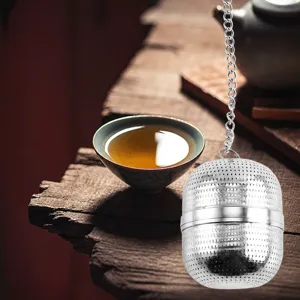 Stainless steel tea infuser ball with chain and hook design for loose leaf tea brewing.