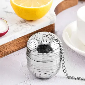 Stainless steel tea infuser mesh ball with chain for loose leaf tea and spice filtration.