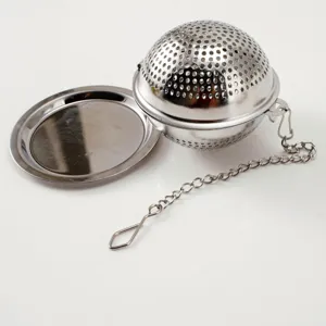 Stainless steel tea infuser ball with chain and drip tray for loose leaf tea brewing.