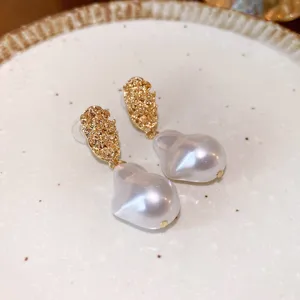 Elegant irregular baroque pearl drop earrings with textured gold-plated top for women fashion.