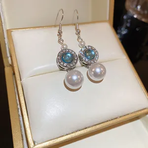 Detail view of Korean style silver needle crystal pearl drop earrings, retro fashion jewelry for women.