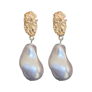 Elegant irregular baroque pearl drop earrings with textured gold top for women, chic and stylish.