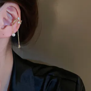 Gold ear cuff with rhinestones, pearl and tassel chain. Elegant non-piercing fashion jewelry.