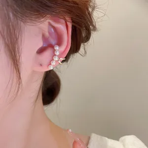Close-up detail of the elegant pearl ear cuff showing the delicate metal and pearl arrangement.