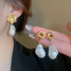 Detailed view of fashionable gold-plated knot and flower pearl drop earrings for women.