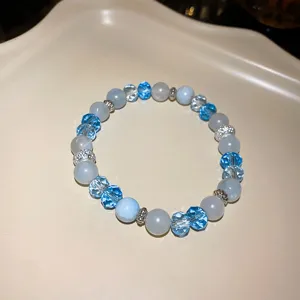 Detailed close-up shot of blue crystal beaded bracelet with sparkling rhinestones.