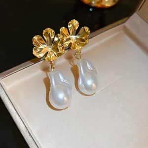 Exquisite gold flower metal and white baroque pearl drop earrings, fine detail shot.