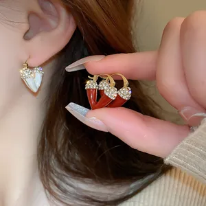 Detailed shot of trendy rhinestone earrings, featuring elegant metal design and sparkling diamonds.