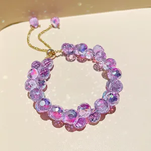 Exquisite purple crystal beaded adjustable bracelet detail, sparkling facets and gold chain.