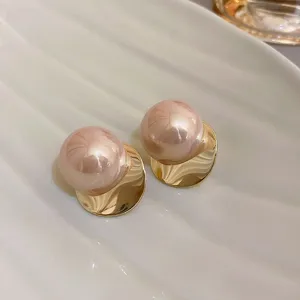 Elegant pink pearl stud earrings with gold metal base for women fashion daily wear chic jewelry.