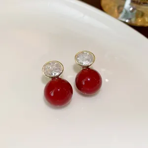 Elegant red ball stud earrings with crystal detail for women, perfect for chic fashion styles.