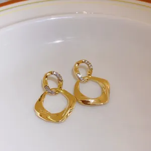 Elegant gold geometric earrings featuring sparkling crystal paved small loops and irregular drops.