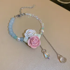 Detailed close-up of the sweet floral crystal bracelet, featuring delicate rose charms and beads.