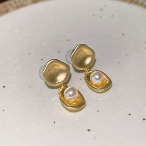 Golden irregular metal pearl drop earrings detail showcasing the French fashion and elegant design.