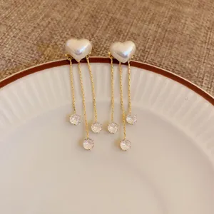 Elegant heart pearl dangle earrings with sparkling zirconia chains for chic daily wear.