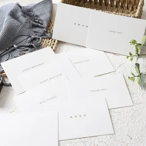 Minimalist white greeting cards with elegant English and Chinese text for special events.