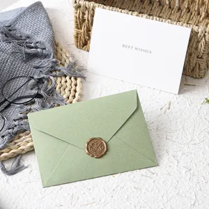 Green envelope with wax seal sticker, vintage tactile paper design for special event greetings.