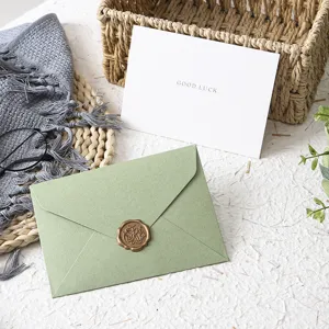 Avocado green envelope set with retro wax seal and greeting card for elegant stationery needs.