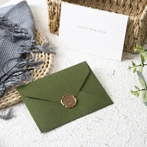 Vintage avocado green tactile paper envelope set with greeting card and wax seal.