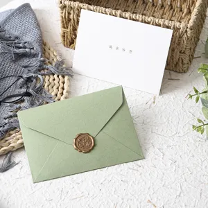 Detailed view of western touch paper avocado green envelope set with greeting card and wax seal.