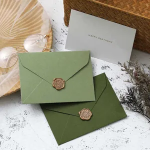 Western touch paper green envelopes set with retro wax seals and greeting cards for events.