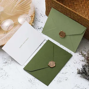 Green paper envelopes set with wax seal and greeting card for retro party and invitation.