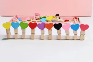 Close-up detail of colorful heart wooden clips arranged neatly for wall photo hanging and crafts.