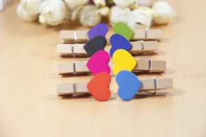 Colorful wooden heart clips detail shot, perfect for photo hanging, notes display and wall decor.