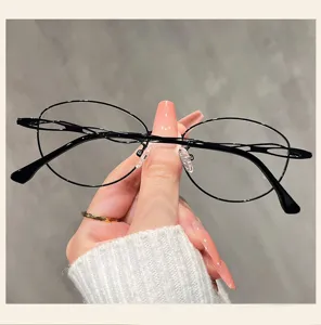 Close up of the stylish black thin rimmed cat eye glasses frame, showing delicate hand details.