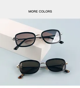 Detailed shot of fashionable metal sunglasses with square frames and gradient lenses.