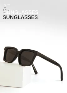 Detailed view of men's square sunglasses with thick black frames and stylish pin temples.