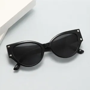 Stylish black cat-eye sunglasses for women with metal stud details and vintage design.