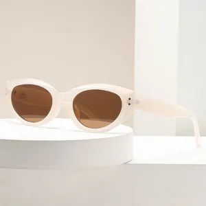 Trendy oval frame sunglasses for women, chic light-colored retro sun glasses with brown lens.