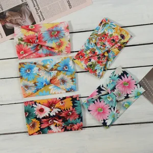 Detailed view of bohemian floral cross headbands, soft stretch fabric hair bands for daily wear.