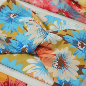 Close-up detail of wide cross elastic floral headband, vibrant vintage daisy pattern fabric