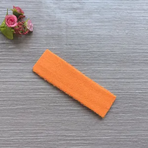 Orange sports headband detail shot, sweat-absorbing cotton fabric for yoga and running fitness.