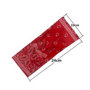 Red paisley print elastic cross sports headband detail view, 24cm by 10cm versatile hair band.