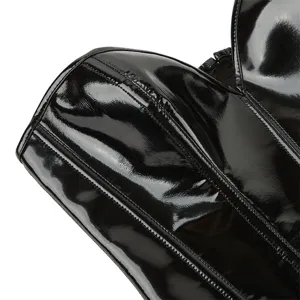 Close-up detail of the black glossy faux leather corset top showing fine boning and texture.