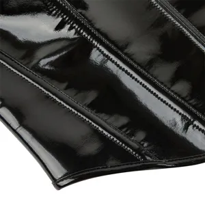 Detail view of the black patent leather corset top, showing fine boning and glossy texture.