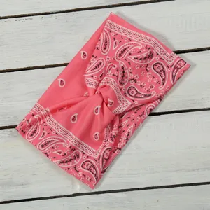 Pink paisley headband for women, stretch knotted hair band, trendy wide fabric hair accessory.