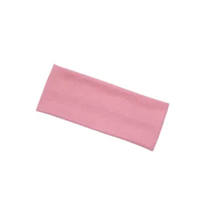 Close-up detail of the pink knitted ribbed headband, soft elastic fabric for daily sports use.