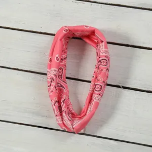 Pink paisley print sports headband detail, elastic wide-brim turban hair accessory.