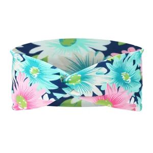Close-up detail of the wide knotted floral headband, showing vibrant cyan and pink print.