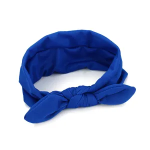 Detailed close-up shot of the royal blue fabric headband with a cute knotted bow design.