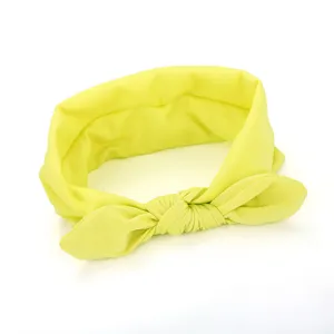Yellow fabric headband detail shot, soft material with cute bow knot design for daily wear.