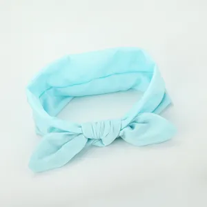 Detail shot of light blue fabric hair band, showing soft texture and cute bow knot design.