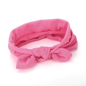 Pink fabric hairband detail showing the soft bow knot texture, ideal for daily cute styling.