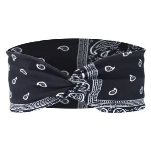 Close-up of black paisley printed twist headband showing fabric texture and knot detail.