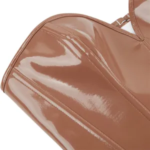 Glossy brown faux leather corset top detail showing boning seams and premium texture finish.