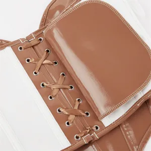 Detail shot of women's glossy patent leather corset bustier with ribbon lace-up.